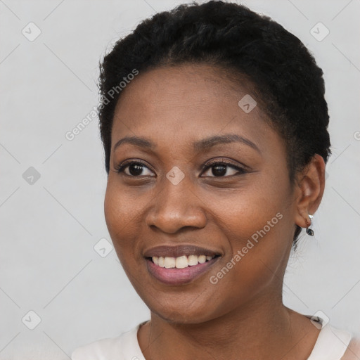 Joyful black young-adult female with short  black hair and brown eyes