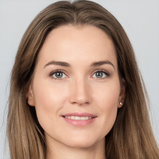 Joyful white young-adult female with long  brown hair and grey eyes