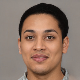 Joyful latino young-adult male with short  black hair and brown eyes