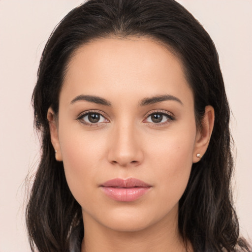 Joyful white young-adult female with long  brown hair and brown eyes