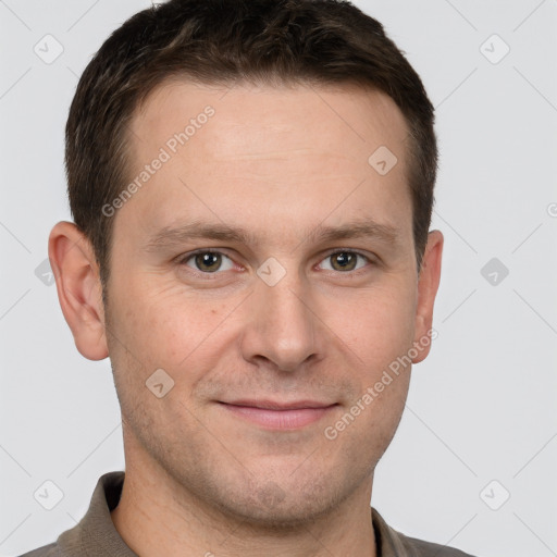 Joyful white adult male with short  brown hair and grey eyes