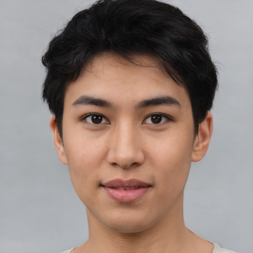 Joyful asian young-adult male with short  black hair and brown eyes