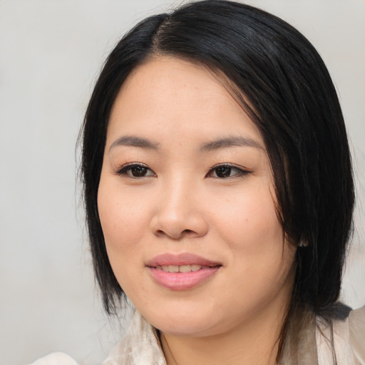 Joyful asian young-adult female with medium  black hair and brown eyes