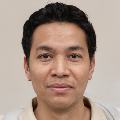 Joyful asian adult male with short  black hair and brown eyes