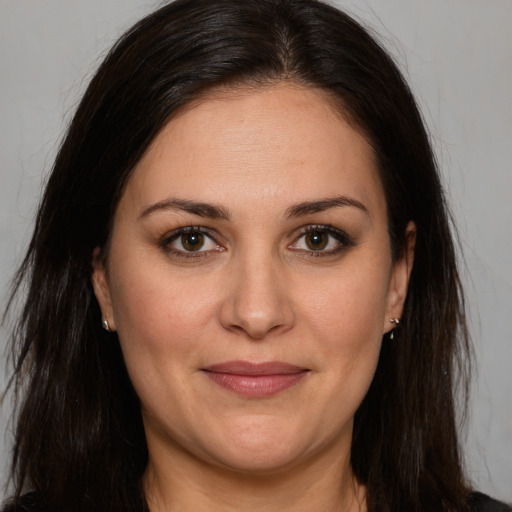 Joyful white adult female with long  brown hair and brown eyes