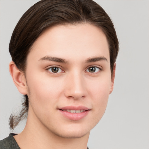 Joyful white young-adult female with short  brown hair and grey eyes