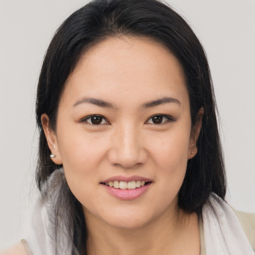 Joyful white young-adult female with medium  brown hair and brown eyes