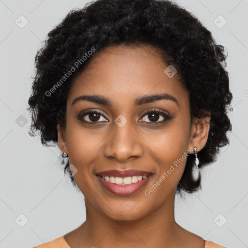 Joyful black young-adult female with long  black hair and brown eyes