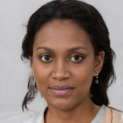 Joyful black young-adult female with medium  brown hair and brown eyes