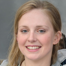 Joyful white young-adult female with medium  brown hair and blue eyes