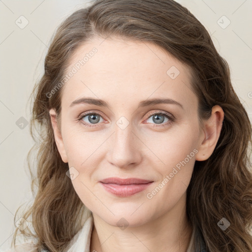 Joyful white young-adult female with long  brown hair and blue eyes