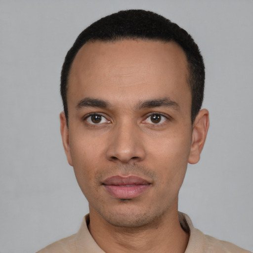 Joyful latino young-adult male with short  black hair and brown eyes