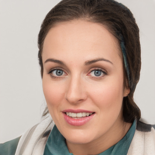 Joyful white young-adult female with medium  brown hair and blue eyes