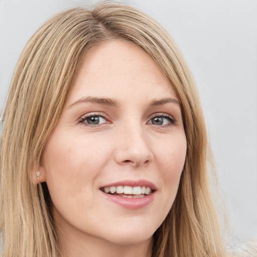 Joyful white young-adult female with long  brown hair and green eyes