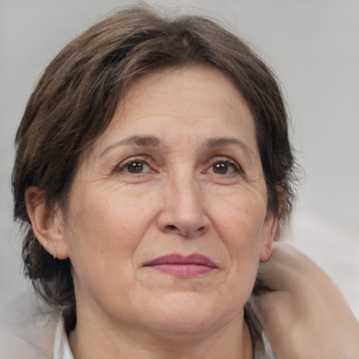 Joyful white adult female with medium  brown hair and brown eyes