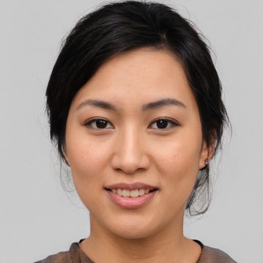 Joyful asian young-adult female with medium  brown hair and brown eyes