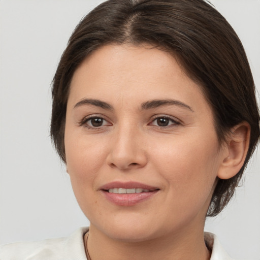 Joyful white young-adult female with medium  brown hair and brown eyes