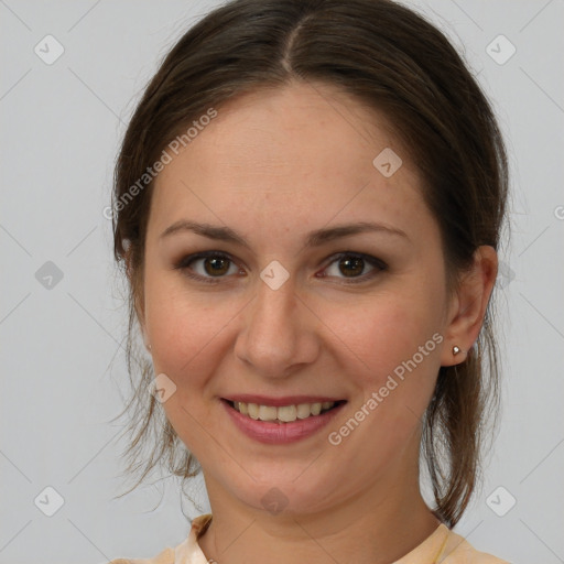 Joyful white young-adult female with medium  brown hair and brown eyes