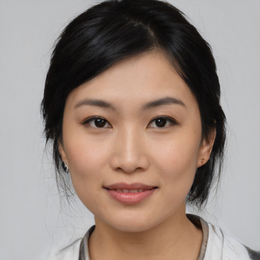 Joyful asian young-adult female with medium  black hair and brown eyes