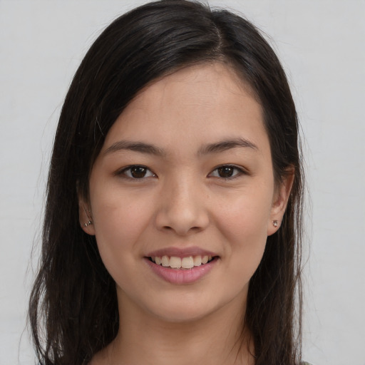 Joyful latino young-adult female with long  brown hair and brown eyes