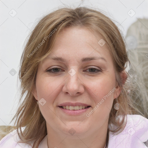 Joyful white adult female with medium  brown hair and blue eyes