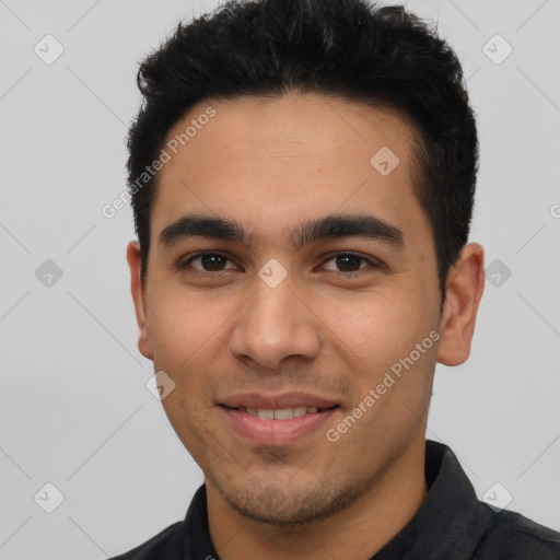 Joyful latino young-adult male with short  black hair and brown eyes