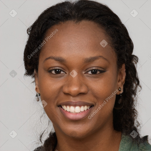 Joyful black young-adult female with long  brown hair and brown eyes