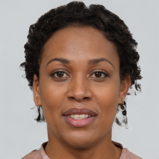 Joyful black adult female with short  brown hair and brown eyes
