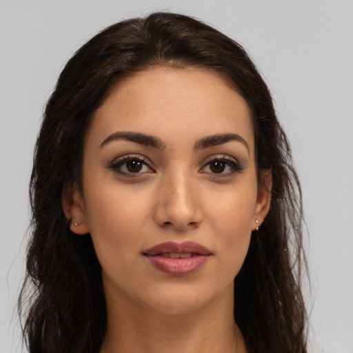 Joyful latino young-adult female with long  brown hair and brown eyes