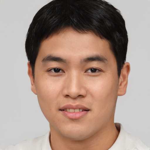 Joyful asian young-adult male with short  black hair and brown eyes