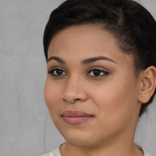 Joyful latino young-adult female with short  brown hair and brown eyes