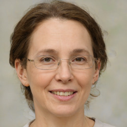 Joyful white adult female with medium  brown hair and grey eyes