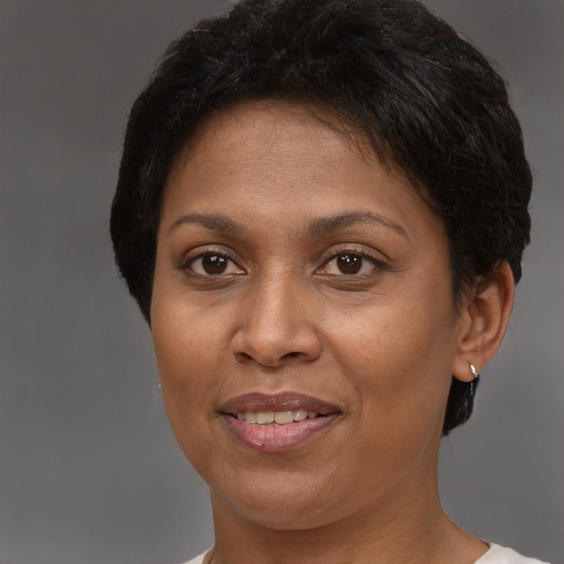 Joyful latino adult female with short  brown hair and brown eyes