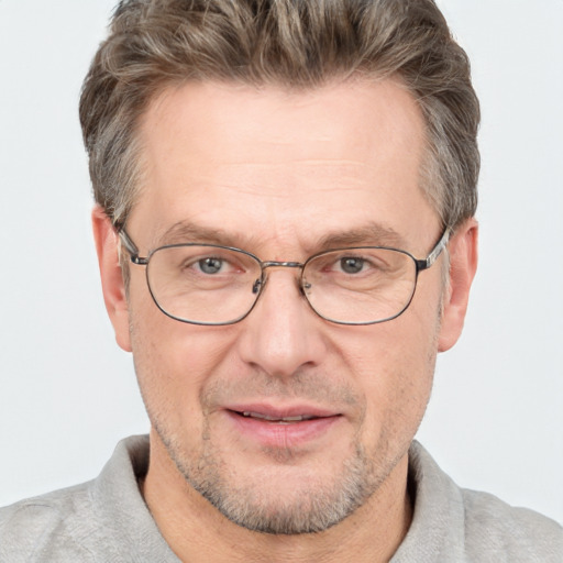 Joyful white adult male with short  brown hair and grey eyes