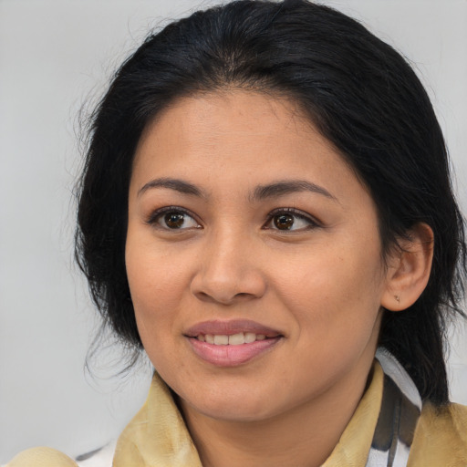 Joyful latino young-adult female with medium  brown hair and brown eyes