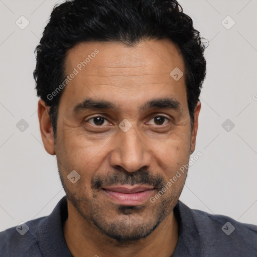 Joyful latino adult male with short  black hair and brown eyes