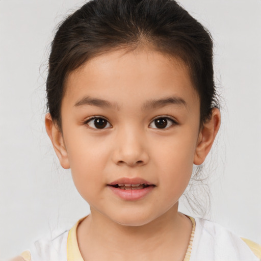 Joyful white child female with short  brown hair and brown eyes