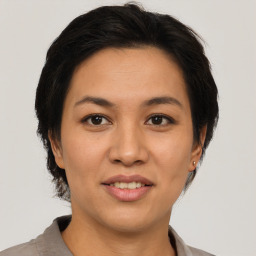 Joyful asian young-adult female with short  brown hair and brown eyes