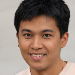 Joyful asian young-adult male with short  brown hair and brown eyes