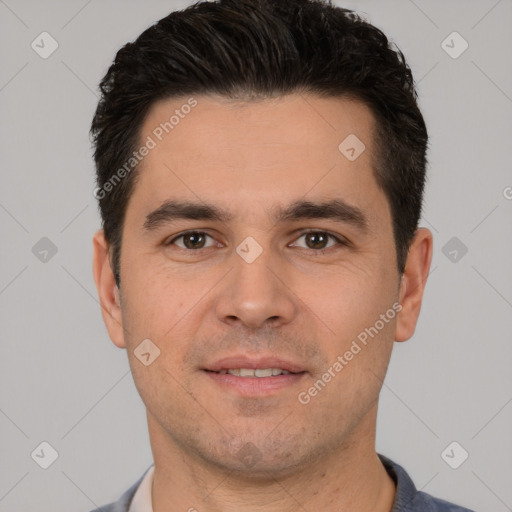 Joyful white young-adult male with short  black hair and brown eyes