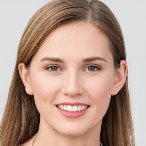 Joyful white young-adult female with long  brown hair and grey eyes