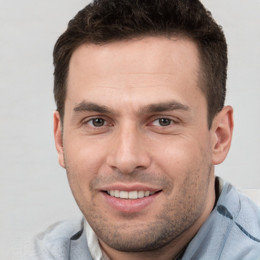 Joyful white young-adult male with short  brown hair and brown eyes