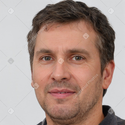 Joyful white adult male with short  brown hair and brown eyes