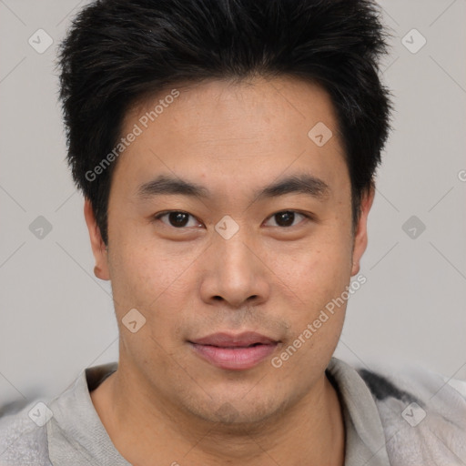 Joyful asian young-adult male with short  brown hair and brown eyes