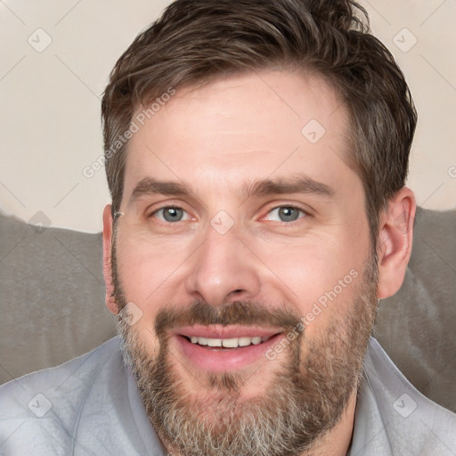 Joyful white adult male with short  brown hair and grey eyes