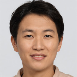 Joyful asian young-adult male with short  brown hair and brown eyes