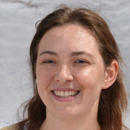 Joyful white adult female with medium  brown hair and grey eyes