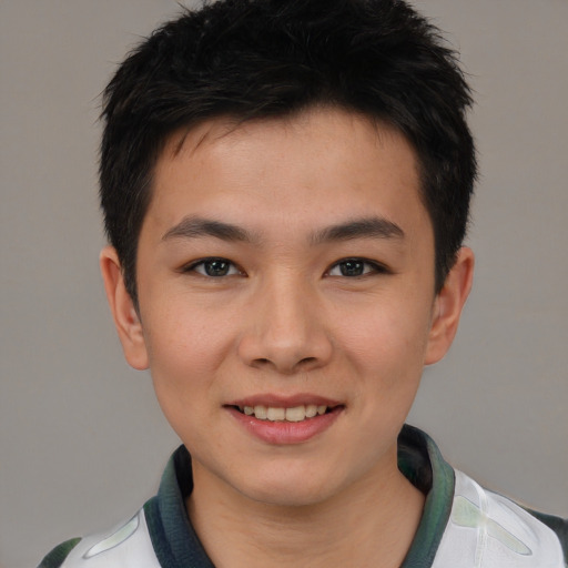 Joyful asian young-adult male with short  brown hair and brown eyes
