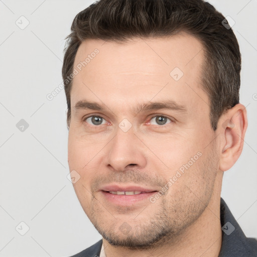 Joyful white adult male with short  brown hair and brown eyes