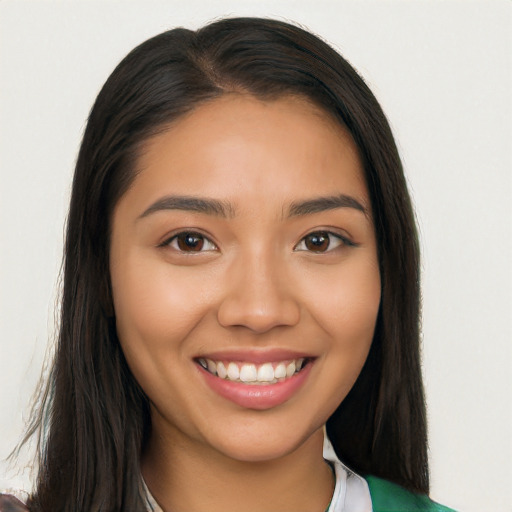 Joyful latino young-adult female with long  brown hair and brown eyes